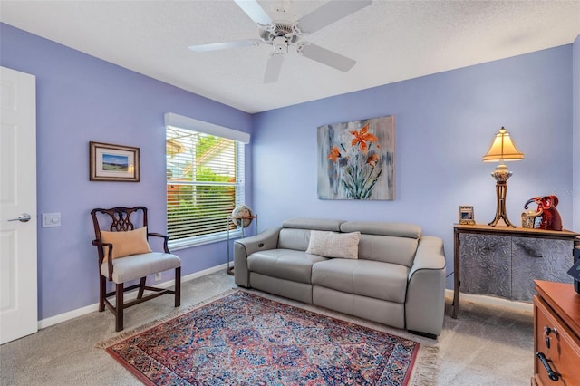 carpeted living room featuring a textured ceiling and ceiling fan