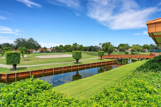 view of home's community featuring a water view and a lawn