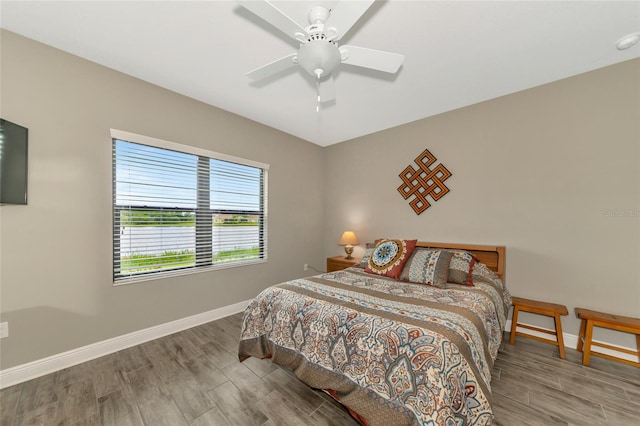 bedroom featuring hardwood / wood-style floors and ceiling fan