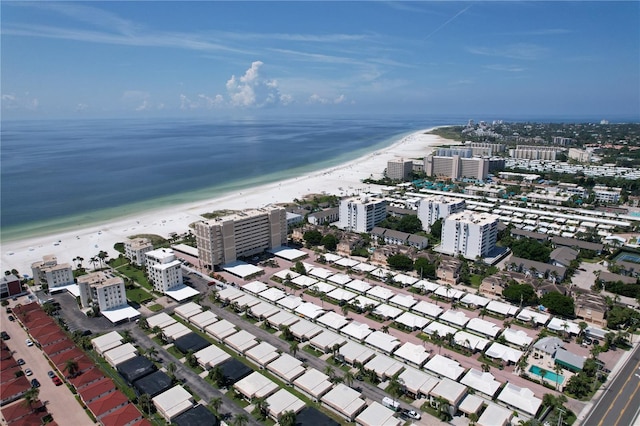 birds eye view of property with a water view and a view of the beach