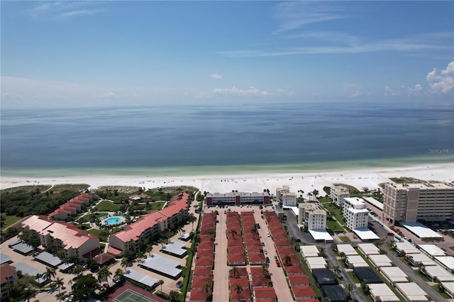 birds eye view of property featuring a water view and a beach view