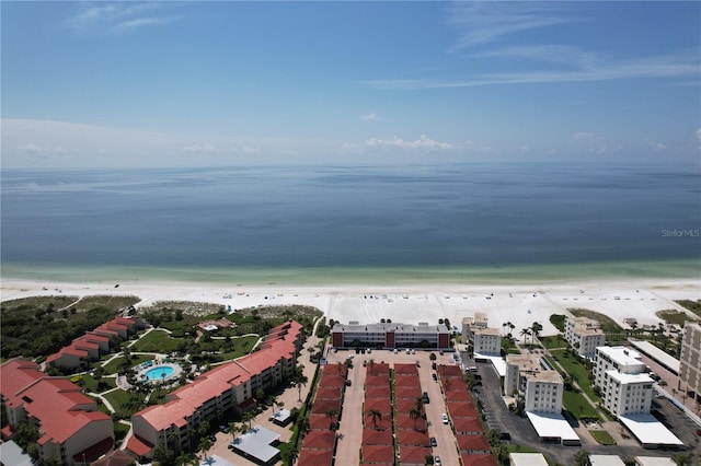 bird's eye view featuring a water view and a beach view