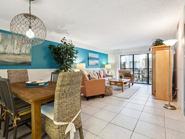 tiled dining space with a textured ceiling