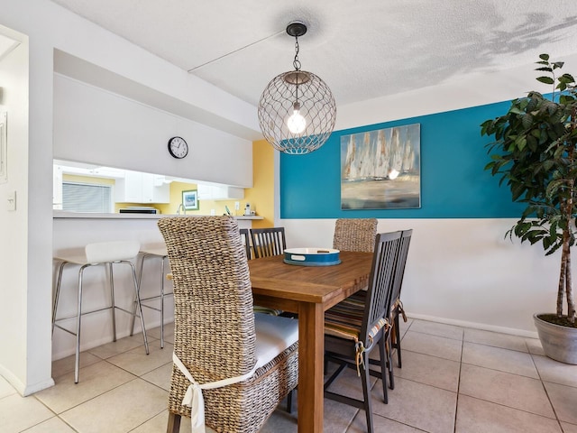 tiled dining area with a textured ceiling