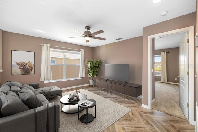 living room with ceiling fan and light parquet floors