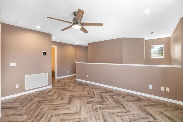 spare room featuring light parquet flooring and ceiling fan