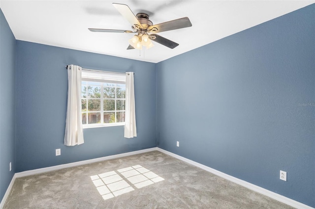 empty room featuring ceiling fan and light colored carpet