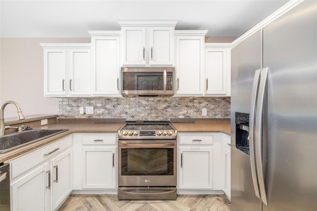 kitchen with decorative backsplash, stainless steel appliances, sink, light parquet floors, and white cabinets