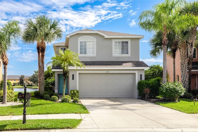 view of front facade featuring a front yard and a garage