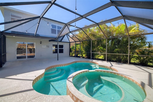 view of pool with a patio area, a lanai, and an in ground hot tub