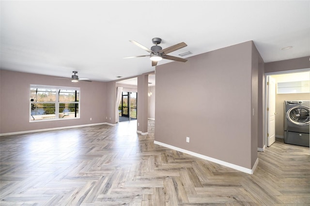 unfurnished living room featuring washer / dryer, ceiling fan, and light parquet flooring