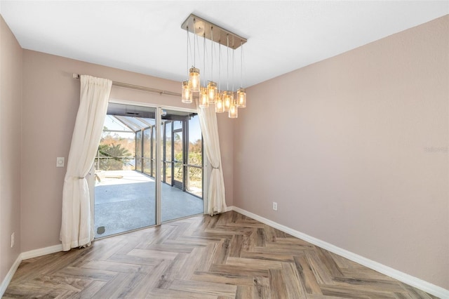 unfurnished dining area featuring an inviting chandelier and light parquet floors