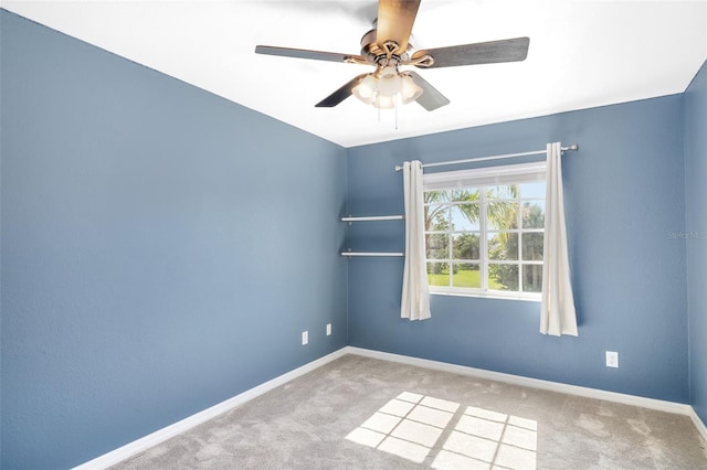 carpeted empty room featuring ceiling fan