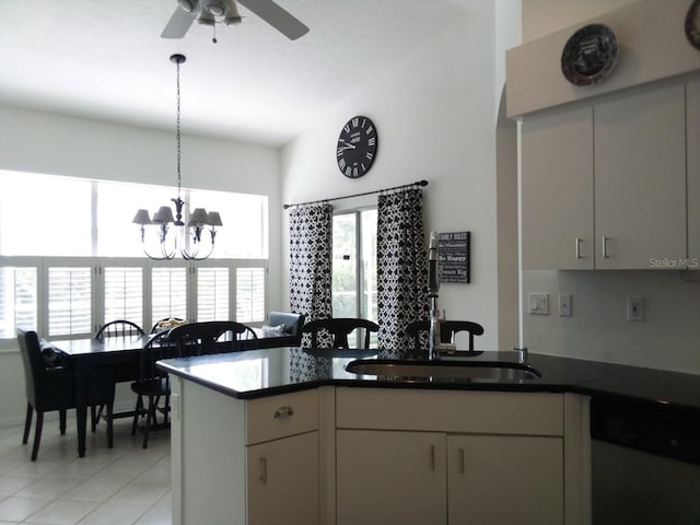 kitchen featuring sink, ceiling fan with notable chandelier, white dishwasher, kitchen peninsula, and light tile patterned floors