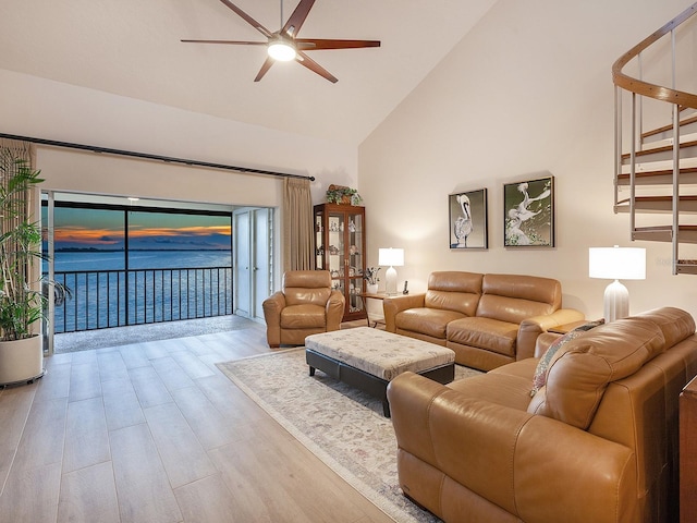 living room with high vaulted ceiling, light wood-type flooring, and ceiling fan