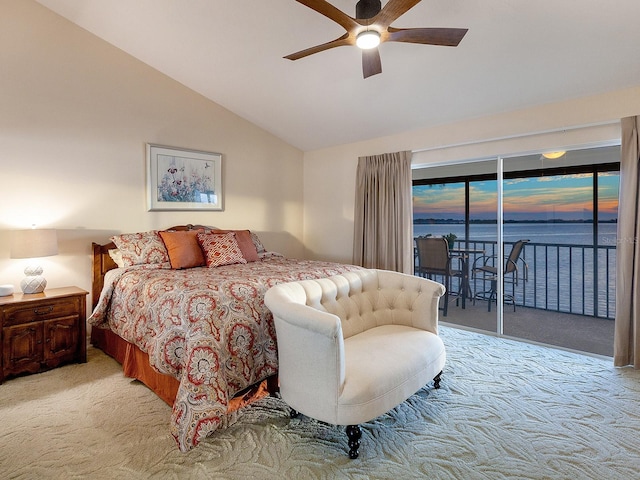 bedroom featuring light carpet, access to exterior, a water view, vaulted ceiling, and ceiling fan