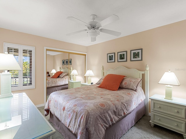 carpeted bedroom featuring ceiling fan and a closet