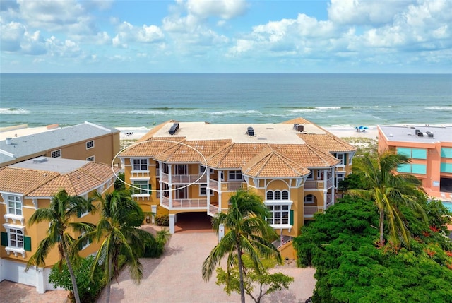 birds eye view of property featuring a water view and a beach view