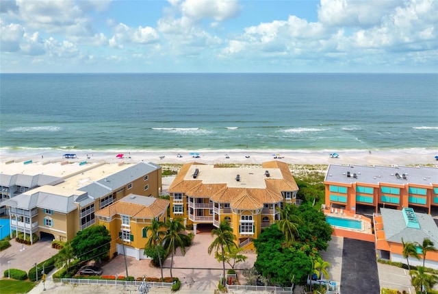 drone / aerial view with a water view and a beach view