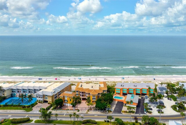 birds eye view of property with a water view and a beach view