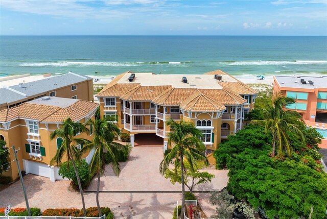 drone / aerial view with a beach view and a water view