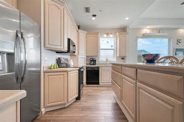 kitchen with electric range, light countertops, black dishwasher, and stainless steel fridge with ice dispenser