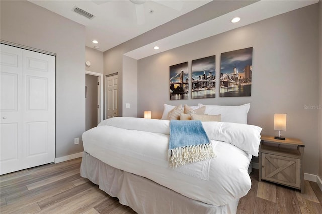 bedroom featuring recessed lighting, wood finished floors, visible vents, and baseboards