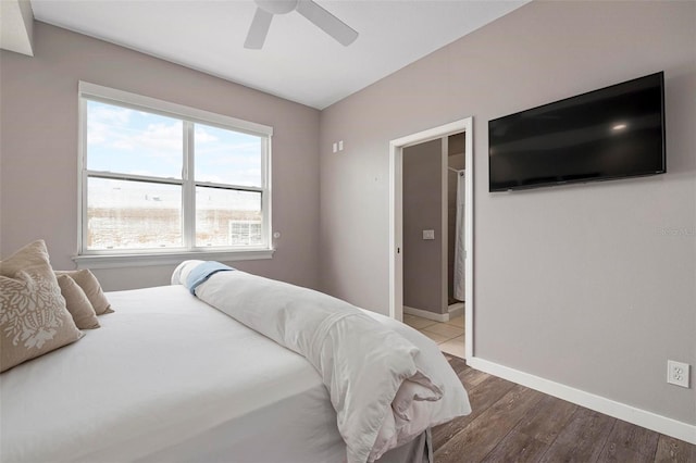 bedroom featuring a ceiling fan, baseboards, and wood finished floors