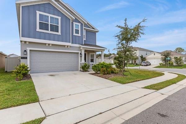 view of front of house with a front yard and a garage