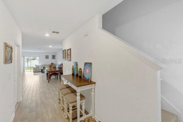 corridor with light hardwood / wood-style flooring