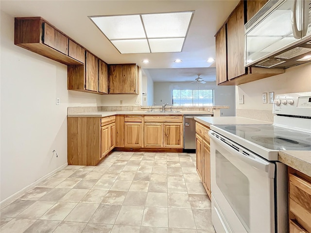 kitchen featuring ceiling fan, light tile patterned floors, sink, and white appliances