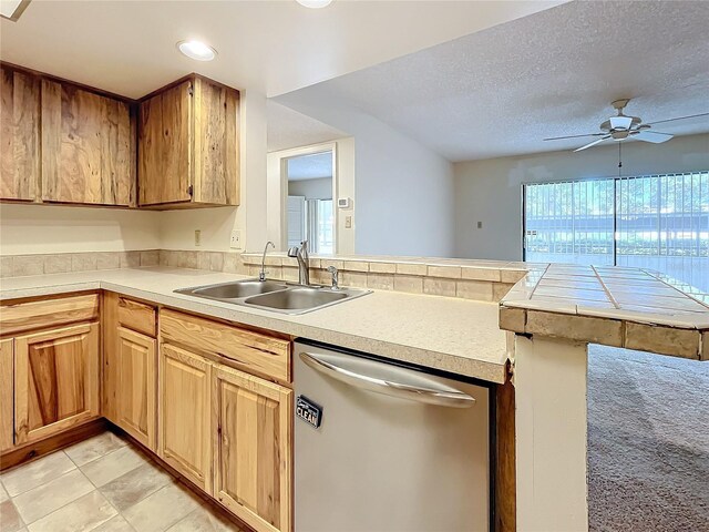 2587 Countryside Blvd Unit 6111, Clearwater, FL 33761 - kitchen with light countertops, dishwasher, a ceiling fan, a sink, and a peninsula