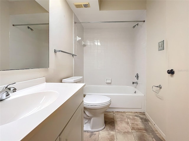 full bathroom with tile patterned flooring, tiled shower / bath, vanity, and toilet