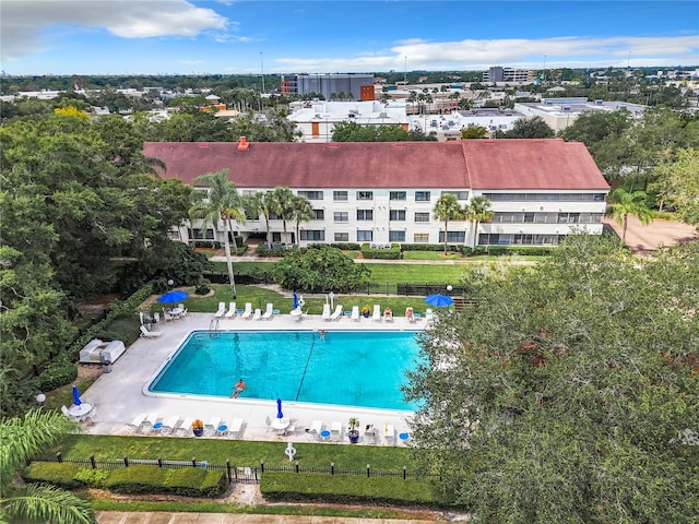 view of swimming pool featuring a patio and a yard