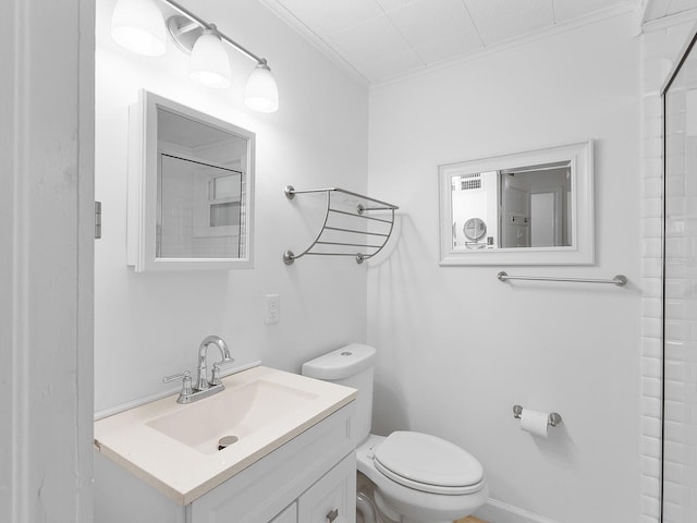 bathroom with toilet, ornamental molding, and vanity