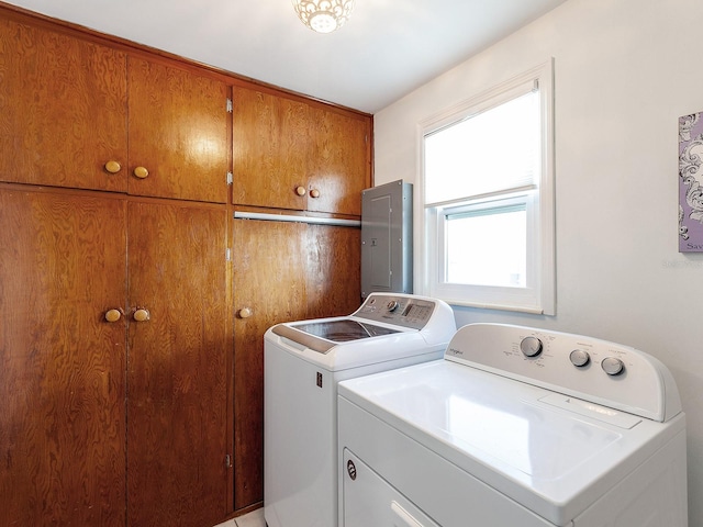 laundry room featuring electric panel, cabinets, and independent washer and dryer