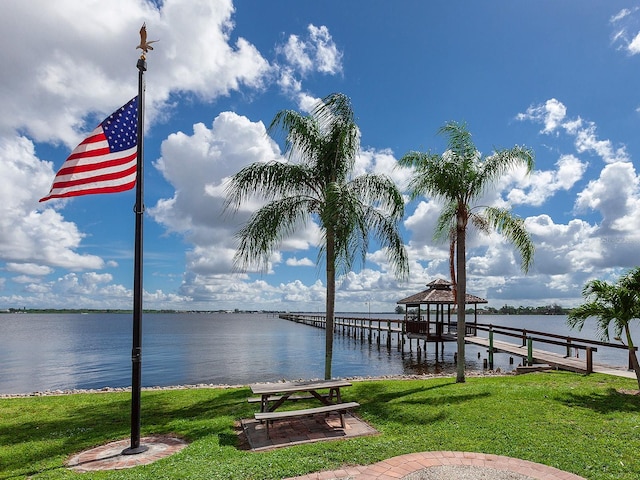 dock area featuring a yard and a water view