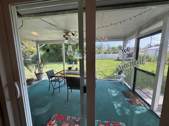 unfurnished sunroom with plenty of natural light and ceiling fan