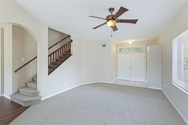 interior space featuring wood-type flooring, ceiling fan, and plenty of natural light