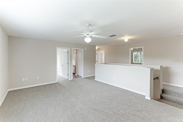 empty room featuring light carpet and ceiling fan