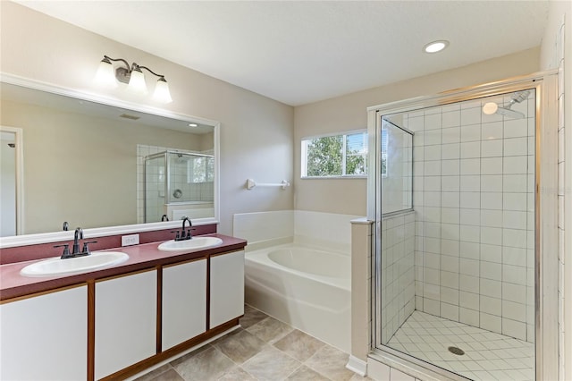 bathroom with tile patterned floors, independent shower and bath, and vanity