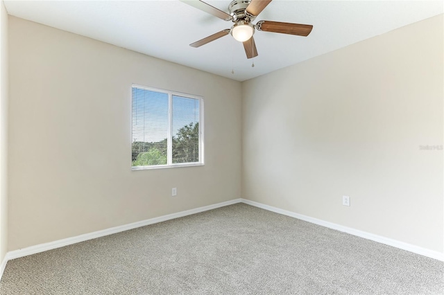 unfurnished room featuring ceiling fan and carpet floors