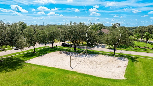 view of home's community featuring a lawn and volleyball court