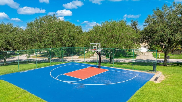 view of sport court with a yard