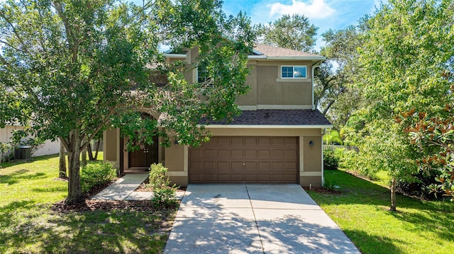 view of property hidden behind natural elements featuring cooling unit, a front yard, and a garage