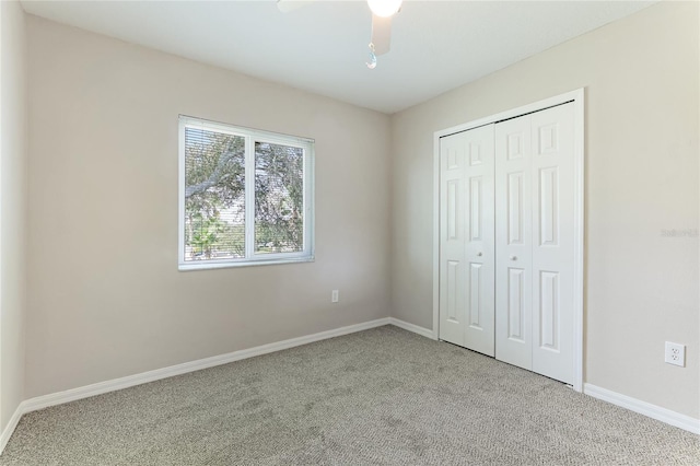 unfurnished bedroom with a closet, ceiling fan, and light colored carpet