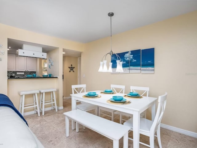 6157 Midnight Pass Rd Unit A51, Sarasota, FL 34242 - dining area with baseboards and light tile patterned floors