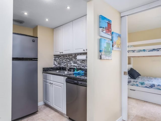 6157 Midnight Pass Rd Unit A51, Sarasota, FL 34242 - kitchen featuring stainless steel appliances, a sink, white cabinets, decorative backsplash, and light tile patterned flooring