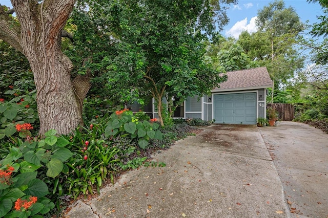 obstructed view of property with a garage