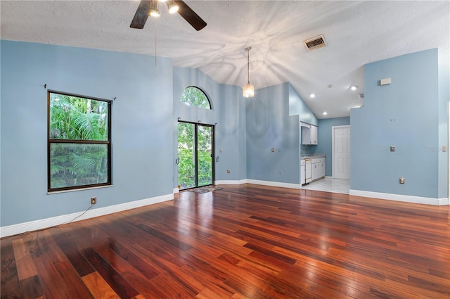 spare room featuring high vaulted ceiling, a textured ceiling, ceiling fan, and dark hardwood / wood-style flooring